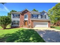 Charming two-story home with a well-manicured lawn, two-car garage and inviting brick accents at 11 Trotters Ne Walk, Cartersville, GA 30121