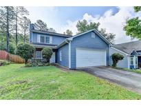 Charming two-story home with a well-manicured lawn and a two car garage in a desirable neighborhood at 200 Mona Ct, Lawrenceville, GA 30044