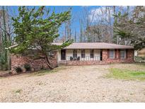 Charming brick home with a well-maintained yard and mature tree in a peaceful, established neighborhood at 5843 Foxfield Trl, Rex, GA 30273