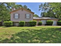 Charming two-story home with a well-manicured lawn and lush landscaping at 3429 Timbercreek Dr, Lawrenceville, GA 30044