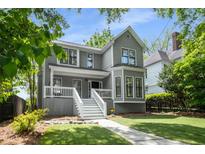 Charming two-story home with a welcoming front porch and beautifully landscaped yard at 907 Edgewood Ave Ne, Atlanta, GA 30307