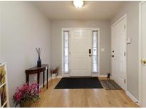 Inviting entryway features a classic white door, sidelights, and hardwood floors at 175 Prince Ct, Hiram, GA 30141