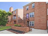 Charming brick townhouse with tidy landscaping and a cozy, welcoming entrance with iron railings and stairs at 87 Davis Mill Ct, Lawrenceville, GA 30044