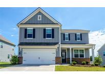 Charming two-story home featuring a two-car garage and classic curb appeal at 4420 Merrigold Way, Fairburn, GA 30213