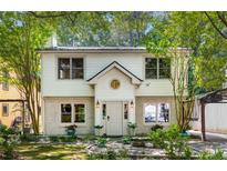 Charming two-story home with a brick foundation, a well-manicured lawn, and mature trees at 1071 Standard Ne Dr, Brookhaven, GA 30319