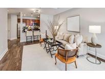 Bright living room with contemporary decor, plush seating, and a view to the kitchen with breakfast bar at 325 E Paces Ferry Ne Rd # 410, Atlanta, GA 30305