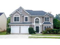 Charming two-story home with a two-car garage and manicured landscaping at 4000 Longlake Dr, Duluth, GA 30097