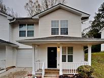 Charming two-story home features a covered front porch and well-maintained landscaping at 1232 Pinedale Nw Cir, Conyers, GA 30012
