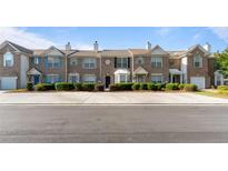Row of two-story brick townhomes with manicured landscaping and individual entrances at 2727 Parkway Trl, Lithonia, GA 30058