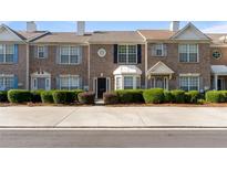 Charming brick townhouse with manicured shrubs and a well-maintained facade at 2727 Parkway Trl, Lithonia, GA 30058