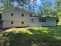 Charming two-story home with beautiful green lawn and white painted brick and siding exterior at 2984 E Paulding Dr, Dallas, GA 30157