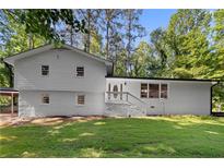 Charming two-story white home with a beautifully manicured lawn and inviting front entrance at 2984 E Paulding Dr, Dallas, GA 30157