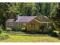 Charming single Gathering home featuring a stone accent entryway and mature landscaping at 1268 Thomas Rd, Decatur, GA 30030