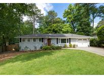 Charming single story home with a well manicured front yard, driveway and garage at 2164 Medfield Trl, Atlanta, GA 30345