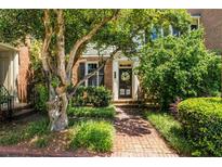 Charming brick townhome featuring a welcoming brick pathway and lush landscaping leading to the front door at 615 Pinetree Dr, Decatur, GA 30030
