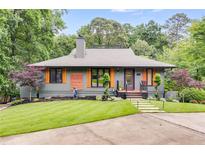 Charming home featuring a well-manicured lawn, modern facade, and beautiful landscaping at 921 Oak Dr, Woodstock, GA 30189