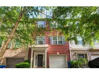 Charming red brick townhouse with a well-maintained front yard and attached garage at 3622 Utoy Dr, South Fulton, GA 30331