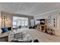 Open living room featuring neutral colors, modern furniture, and a rustic entertainment center, with abundant natural light at 5149 Roswell Rd # 7, Atlanta, GA 30342