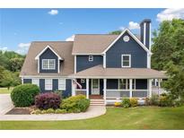 Charming two-story home with covered porch, manicured lawn and tasteful landscaping at 2545 Hickory Level Rd, Villa Rica, GA 30180