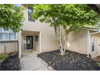Inviting exterior of home featuring tidy landscaping and covered entryway at 1924 Variations Ne Dr, Atlanta, GA 30329