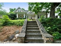 Charming two-story home with stone stairs, landscaped yard, and covered front porch at 1276 Lanier Ne Blvd, Atlanta, GA 30306