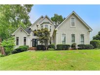 Charming two-story home featuring manicured lawn, and a beautiful facade at 1595 Chadberry Way, Lawrenceville, GA 30043