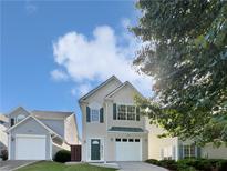 Charming two-story home featuring a manicured lawn, two-car garage, and classic architectural details at 3968 Oak Glenn Dr, Duluth, GA 30096