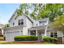 Charming two-story home featuring a well-manicured lawn, covered porch, and attached two-car garage at 1607 Boulder Walk Se Dr, Atlanta, GA 30316