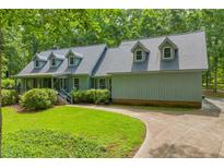 Charming home with beautiful landscaping and a spacious driveway offers a welcoming curb appeal at 740 Skyline Dr, Covington, GA 30014