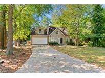 Charming two-story home with a well-manicured lawn and a spacious driveway leading to a two-car garage at 1333 Laura Ln, Austell, GA 30168