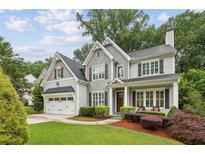 Charming two-story home with a well-manicured lawn, garage, and inviting front porch at 2585 Drew Valley Ne Rd, Brookhaven, GA 30319