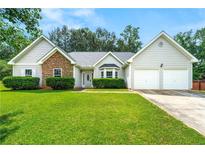 Charming single-Gathering home with stone accents, a well-manicured lawn, and an attached two-car garage at 85 Old Gettysburg Way, Dallas, GA 30157