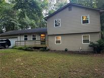 Charming two-story home with neutral siding, a front porch, and well-maintained landscaping at 3474 Leaf Land Ct, Duluth, GA 30097