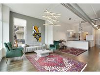 Bright and airy living room boasts modern light fixture, and comfortable seating, with an open flow to the kitchen at 3820 Roswell Ne Rd # 510, Atlanta, GA 30342