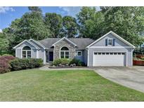 Charming home with lush lawn, stone accents, and two car garage at 1882 Flowering Dr, Grayson, GA 30017