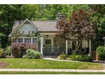 Charming home with stone accents, covered porch, and lush landscaping at 1256 Euclid Ne Ave, Atlanta, GA 30307