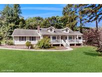 Charming home with a front porch, well-maintained lawn, mature trees, and attractive landscaping at 6 Fairfield Dr, Ellenwood, GA 30294