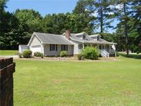 Charming one-story home featuring a lush lawn, attached garage, and inviting front porch at 6 Fairfield Dr, Ellenwood, GA 30294