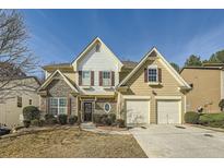 Charming two-story home with stone accents, inviting entrance, and two-car garage at 2331 Flowerdale Ct, Douglasville, GA 30135