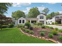 Charming home with landscaped front yard, rock border, and lush green grass at 1815 Coventry Rd, Decatur, GA 30030