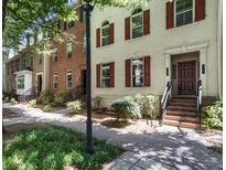 Charming multi-story brick and painted-brick townhomes with red shutters line the street at 2728 Wander Ln, Alpharetta, GA 30022
