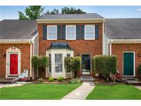 Charming brick townhouse with manicured front lawn and bay window at 1368 Poplar Pointe Se, Smyrna, GA 30082