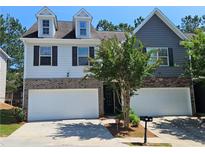 Charming two-story home featuring a two-car garage, brick accents, and a well-maintained front yard at 2141 Spikerush Way, Buford, GA 30519