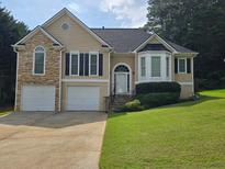 Charming two-story home boasts a two-car garage, manicured lawn, and inviting curb appeal at 33 Evans Point Pt, Dallas, GA 30157
