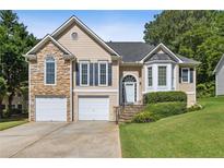 Charming home with stone accents, two-car garage, landscaped yard, and inviting front entrance at 33 Evans Pt, Dallas, GA 30157