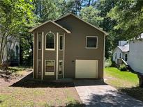 Charming two-story home with unique architectural details and an attached one car garage at 4433 Ford Pl, Snellville, GA 30039