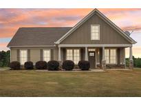 Charming single-story home with a welcoming front porch and well-manicured lawn at 625 Henderson Mill Rd, Covington, GA 30014