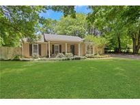 Charming ranch-style home featuring a well-manicured lawn and inviting front porch at 1605 Saddlecreek Rd, Auburn, GA 30011