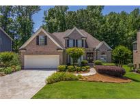 Charming brick home boasts a well-manicured lawn and inviting curb appeal at 1668 Macy Ln, Lawrenceville, GA 30043