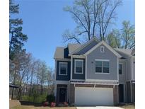 Charming two-story home featuring an attached garage, brick accents, and a well-maintained front lawn at 201 Jonquil Spring Rd, Woodstock, GA 30188